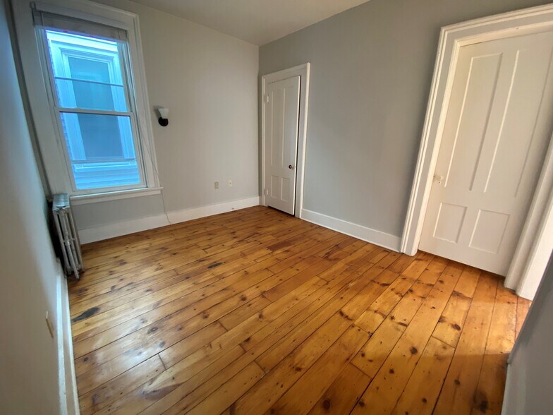 Bedroom #1 features a nice sized closet, new custom cellular blinds, full-sized bed frame, nightstand, desk, dresser - 55 Pearl St