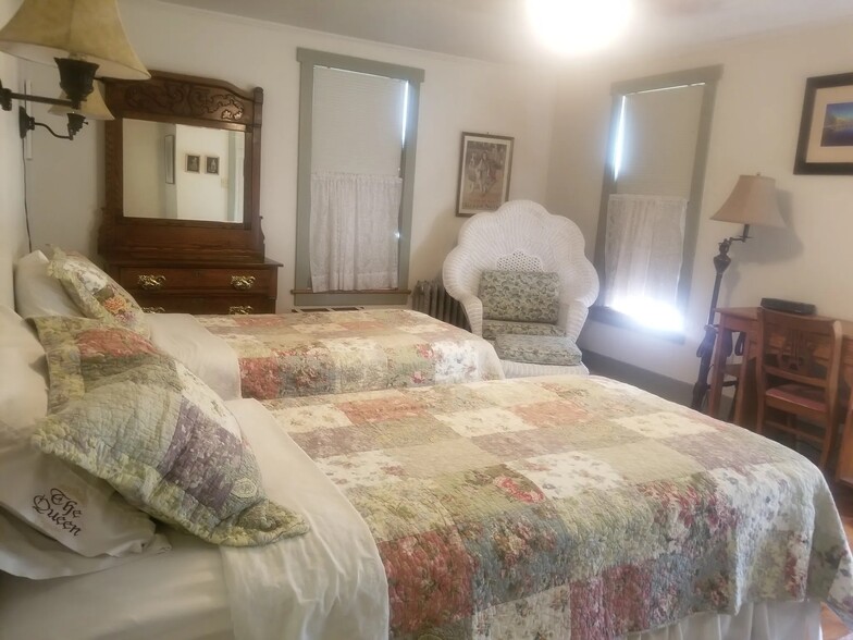Bedroom with two twin beds, closet, dresser, desk. - 227 E Lamb St