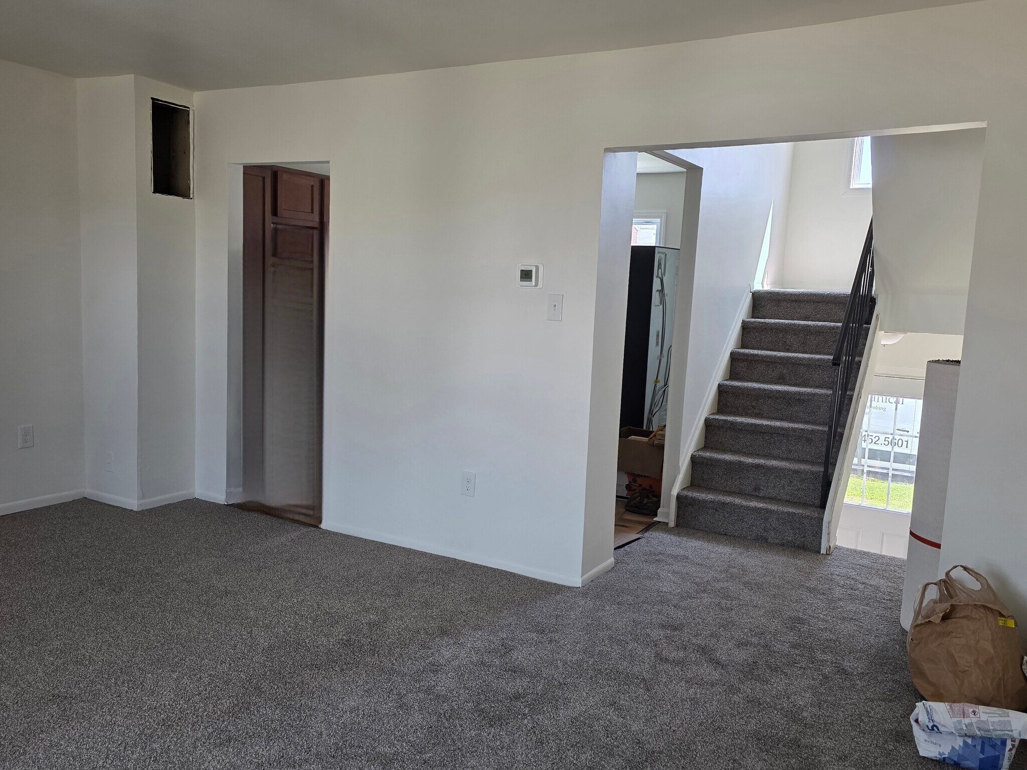View from corner of living room to kitchen and stairs up to front door - 1718 Judy Way