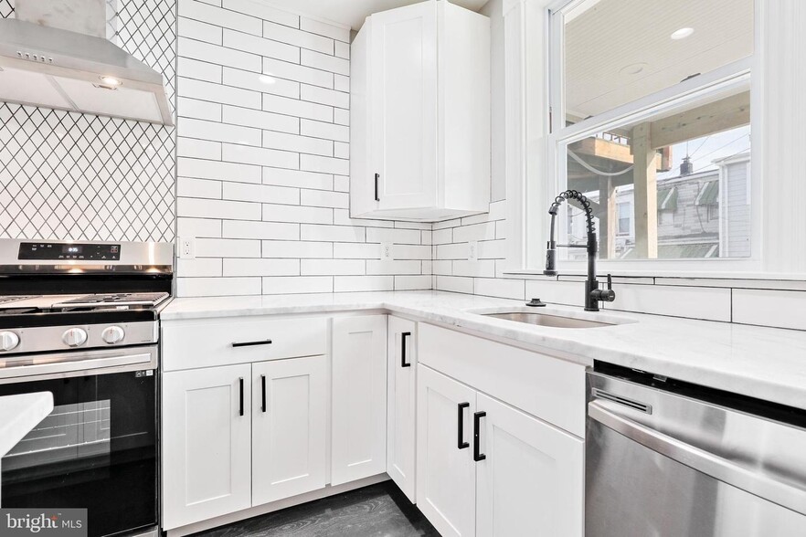 Showing the Kitchen with soft close cabinets and window to the back patio (2 of 2) - 263 S Robinson St