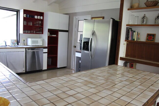 Kitchen with stainless steel appliances in vaulted ceiling kitchen - 426 Ilimano St