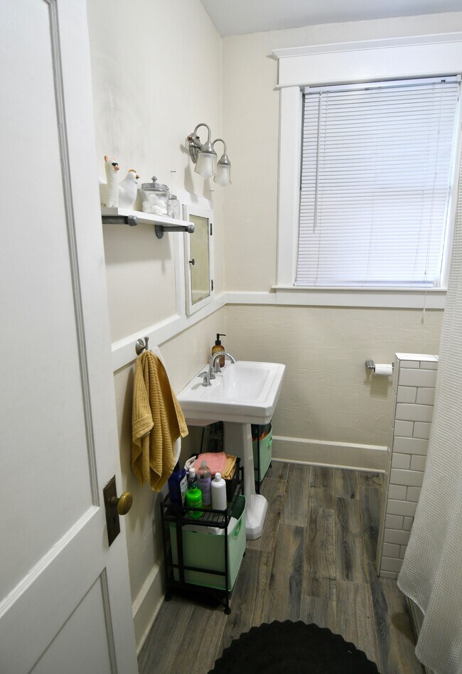 Bathroom with pedestal sink and tub/shower combo - 2027 Baringer Ave