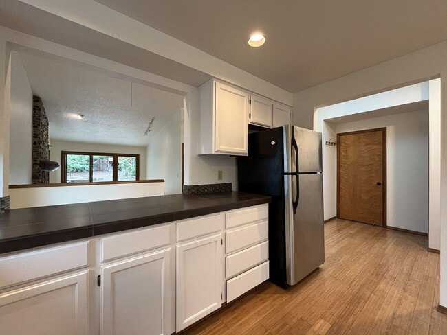Building Photo - Spacious 3-Bedroom Home with Custom Stone Fireplace, Attached 2-Car Garage & Expansive Backyard i...