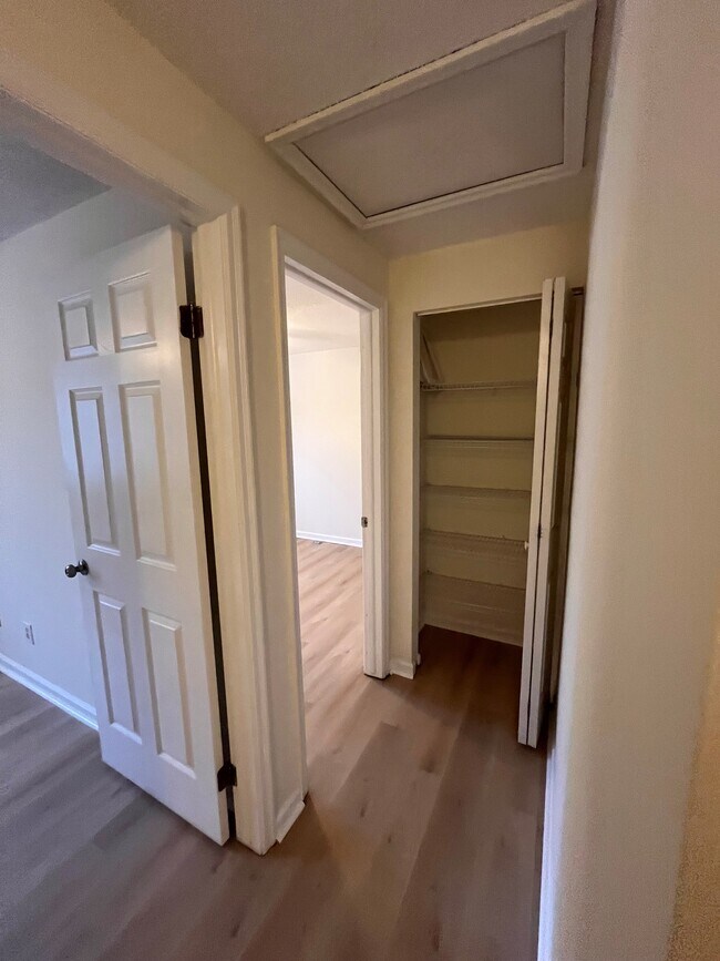 Hallway to bedroom #2 (first on left), Bedroom #3, and linen closet - 9908 Whitney Cir
