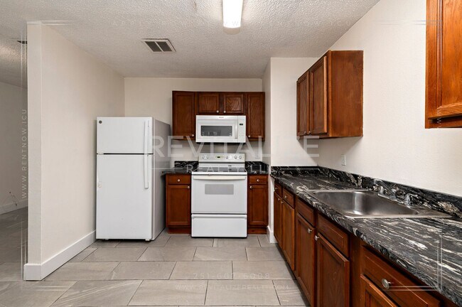 Building Photo - 3 BR 2 BA Home with Fenced Yard & Carport