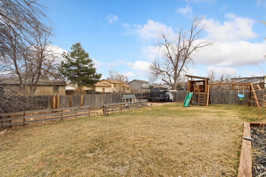 Spacious backyard with playscape. - 3418 Stratton Dr