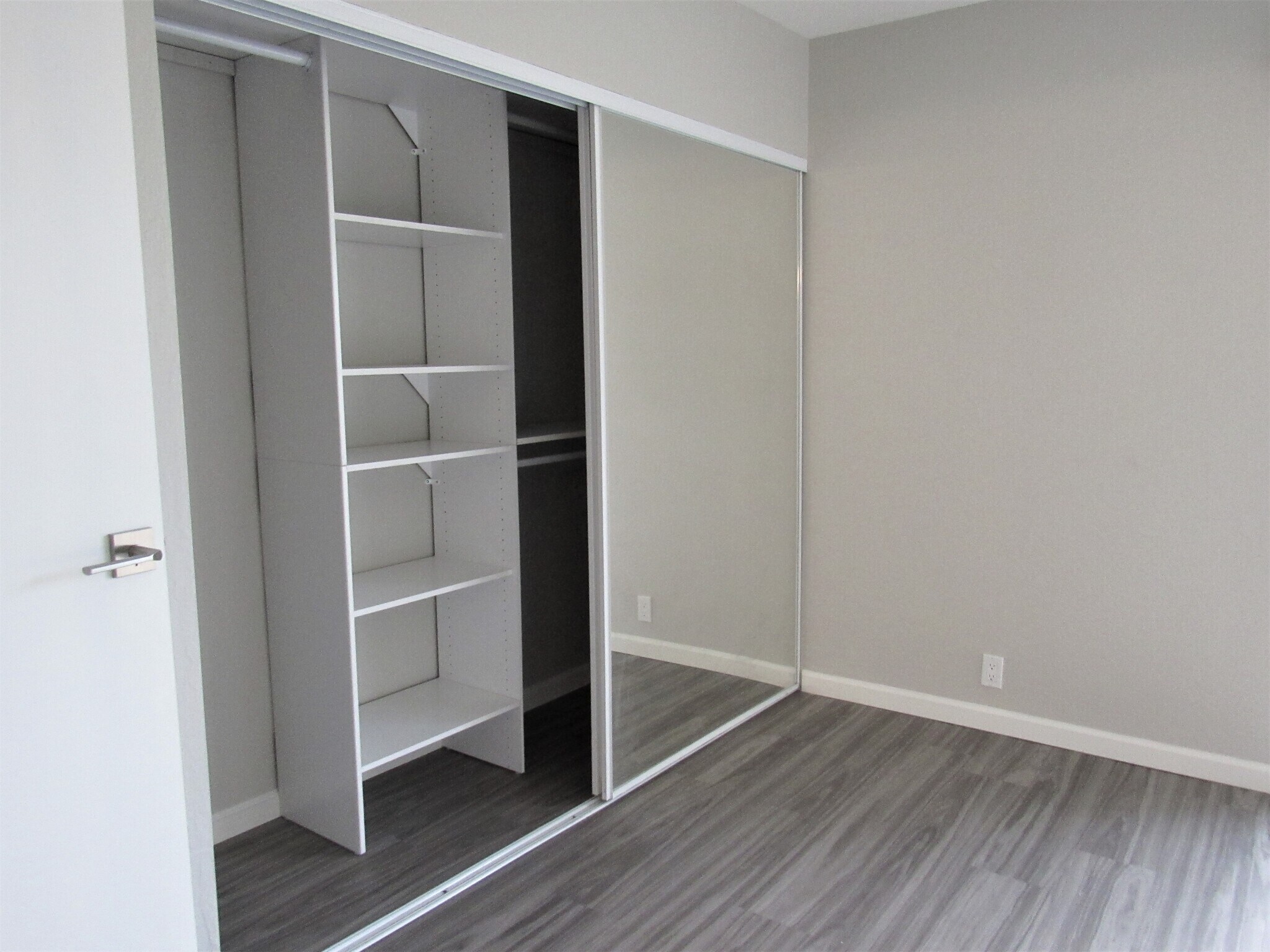 Master bedroom with mirrored doors and closet organizers - 4620 N 68th St