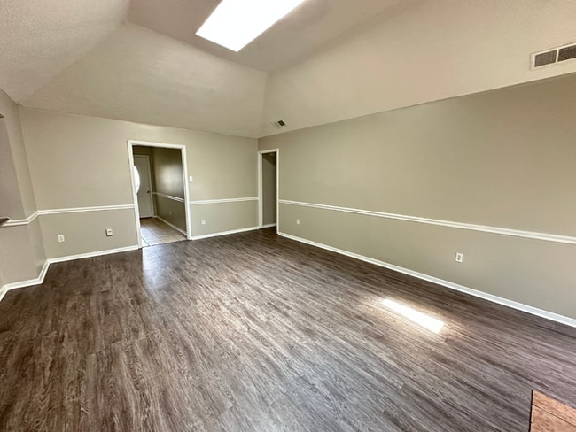 Building Photo - Charming 3BR/2BA Near Southwind | Soaring Vaulted Ceilings, Rustic Fireplace & Garage