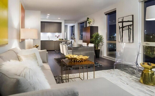 Apartment Interior with Multiple Seating Areas and Floor-to-Ceiling Windows - Pike Motorworks