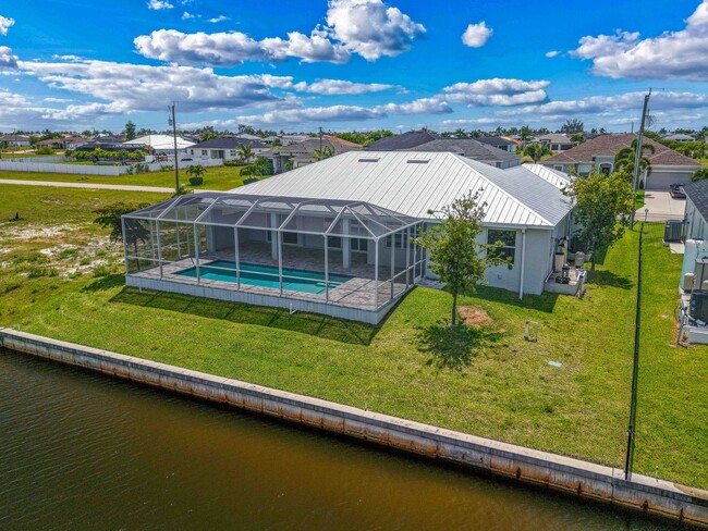 Building Photo - NOW AVAILABLE - Gorgeous Pool Home ~ NW Cape ~ 3 Car Garage ~ On Canal!