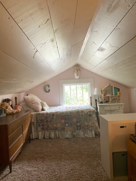 Charming upstairs bedroom features shiplap ceiling - 1003 Egan St