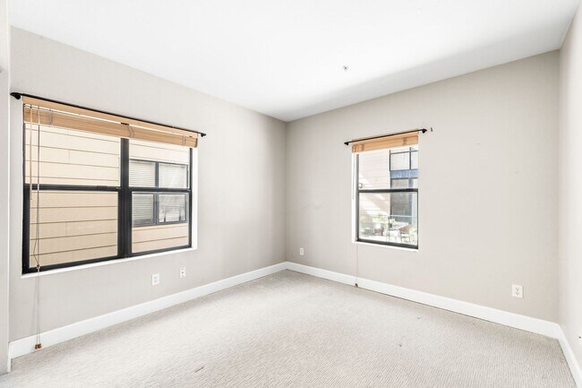 Building Photo - Modern 2BD, 1.5BA Condo with 20' Ceilings and Garage Parking Spot