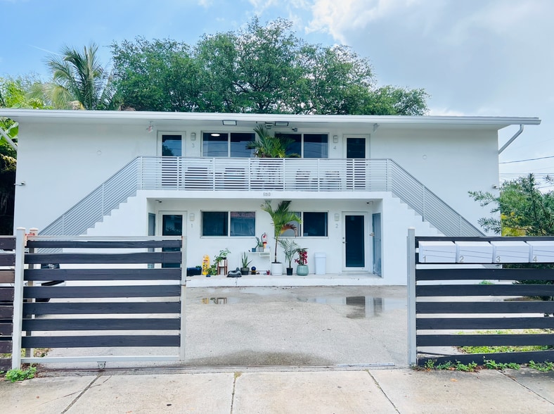 The building with rolling gate open - 6863 NW 2nd Ave