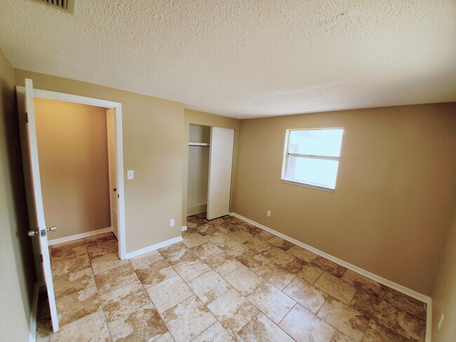 Building Photo - Three bedroom one and a half bathroom house with large yard space