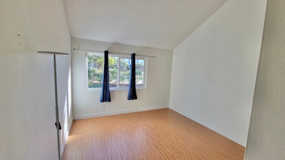 Overlooks trellis of the patio. There are trees and plants up the hill that provide privacy. - 9505 Easter Way