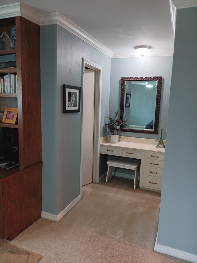 Primary bedroom built-in vanity. Walk in closet to the left and bathroom to the right. - 2308 Wesley Cir
