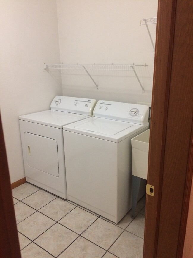 Spacious laundry room with utility sink. - 1415 Knollwood Ave