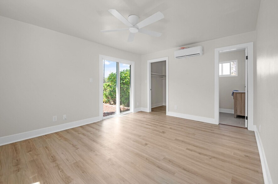 Master bedroom with view of outside, closet and master bath - 9211 Earl St