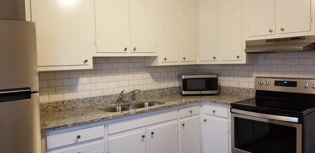 All of the kitchens feature granite tops, subway tile backsplash, stainless steel appliances - 699 Chestnut St