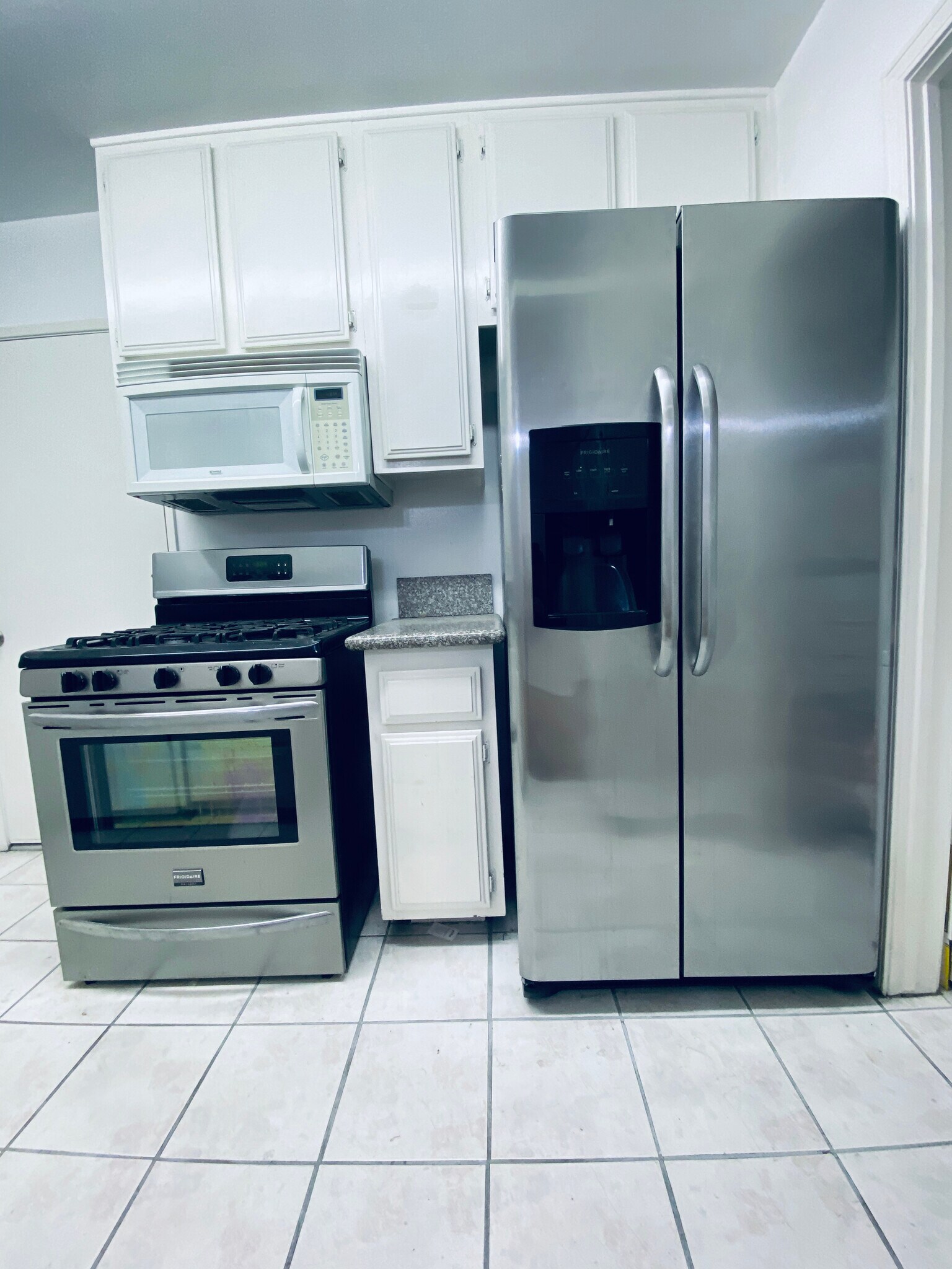 white and stainless steel kitchen - 5876 Bowcroft St