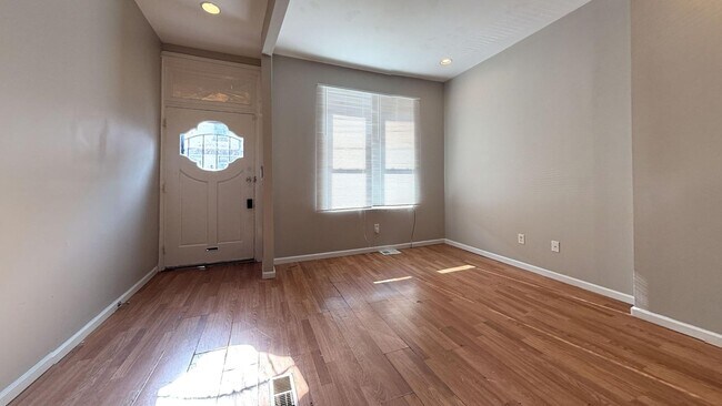 Building Photo - Charming 4BR/2BA Rowhouse with Hardwood-Style Flooring Throughout
