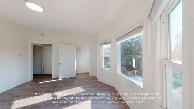 Living room with windows, wood-like flooring, and closet - 2410 Dwight Way