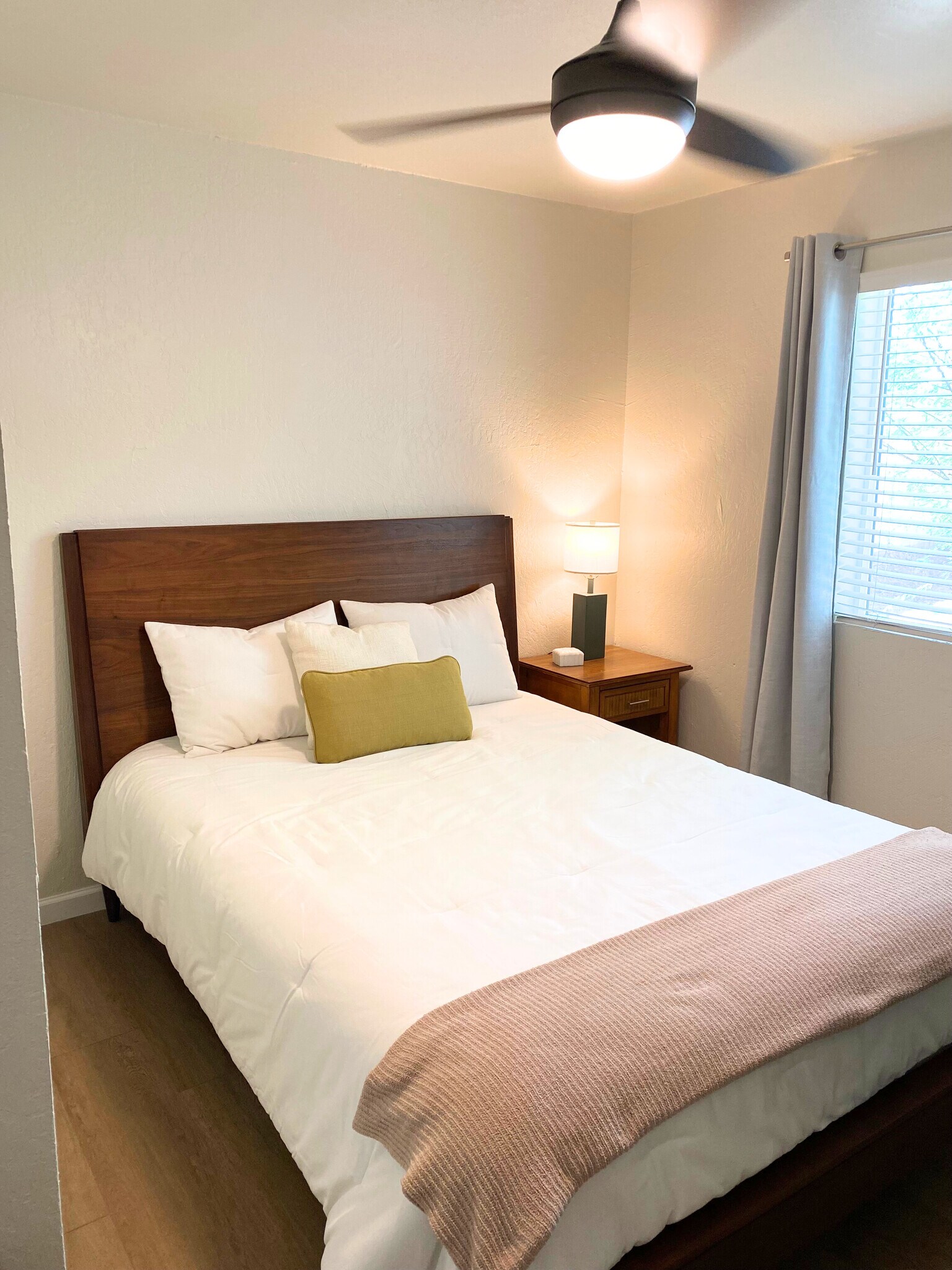 Cozy queen-size bed for a perfect night's sleep with a table lamp & closet. - 1795 W 28th St