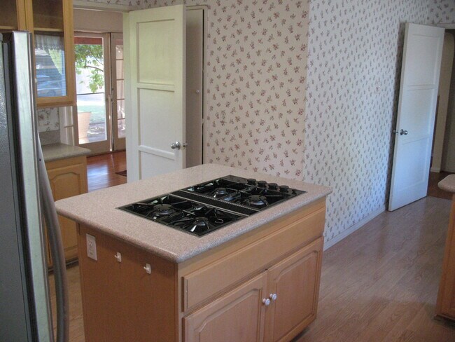 Kitchen View - Island with brand new cooktop stove and entry to dining and living room area - 3121 W Wyoming Ave