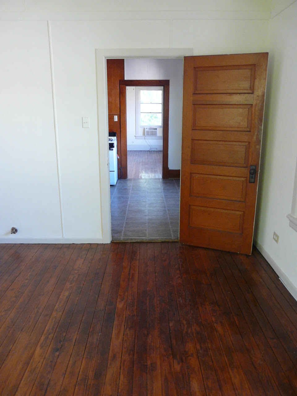 View into kitchen and bedroom from living room - 615 W Oak St