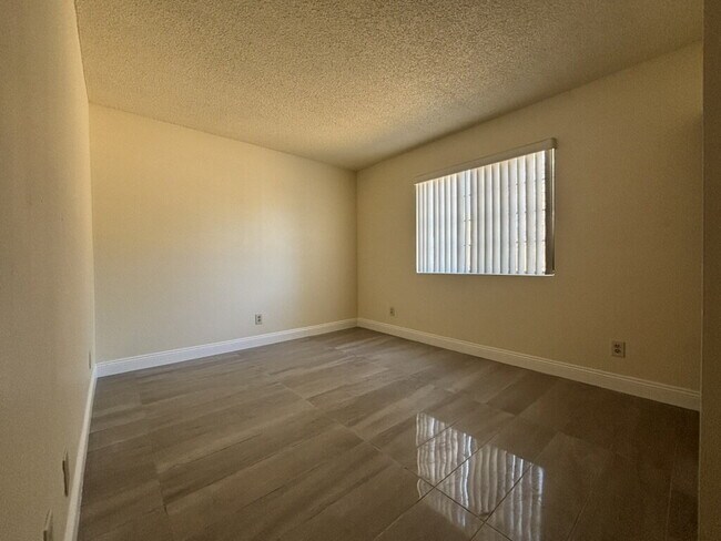 Building Photo - Downstairs 2BR/1BA—recently updated with new flooring, new countertops, and clean, neutral finishes.
