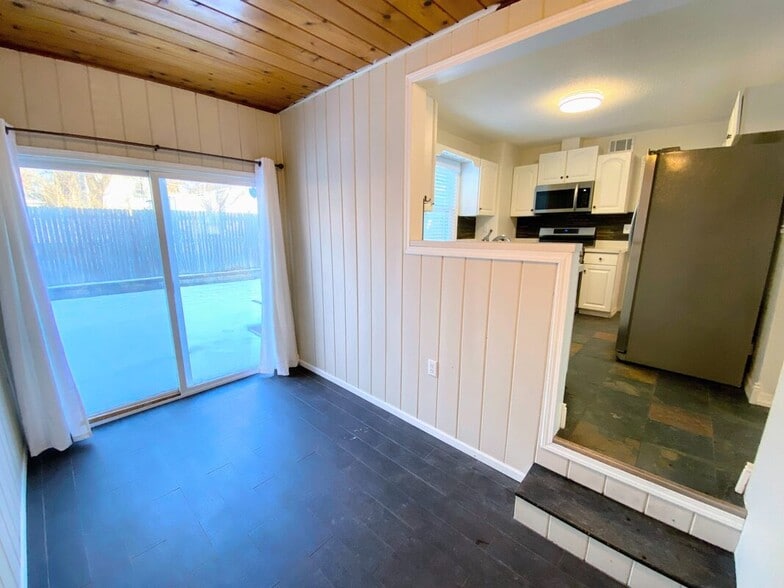 Dining Area - Wood-paneled ceiling and sliding door to the backyard deck - 710 Sheridan Avenue North