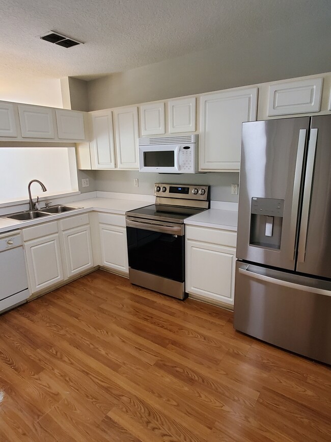 Kitchen with new stove and refrigerator - 1256 Standridge Dr