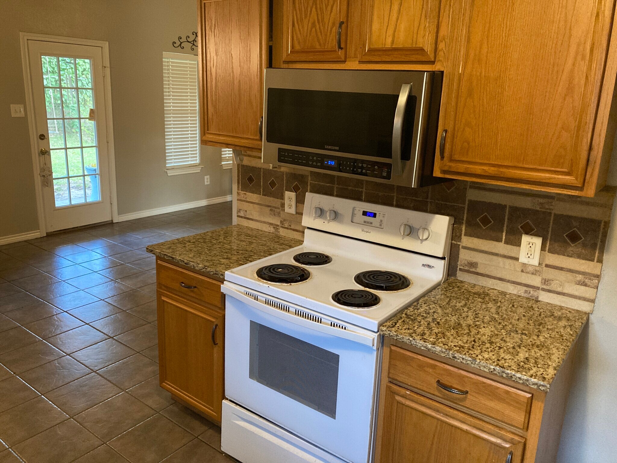 Kitchen has granite countertops, over the range microwave. - 16485 County Road 164