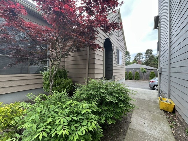 Building Photo - Three-Bedroom Home with Updated Kitchen & Vaulted Ceilings, large open basement, Hardwood floors