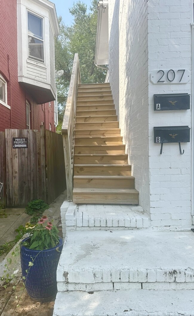 Stairs up to unit. - 207 W 5th St