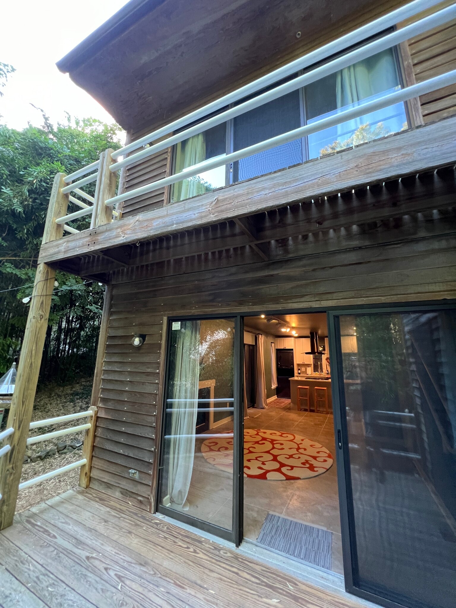 back deck off living area, bedroom 1 deck above - 130 E Longview St