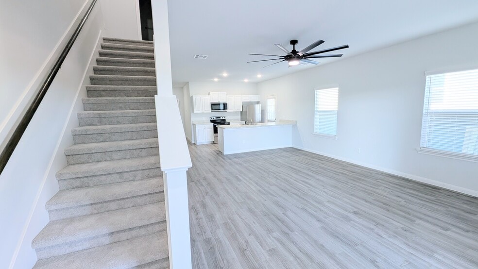 Staircase off the living space leads to two bedrooms and a full bathroom. - 13218 HP Johnson St