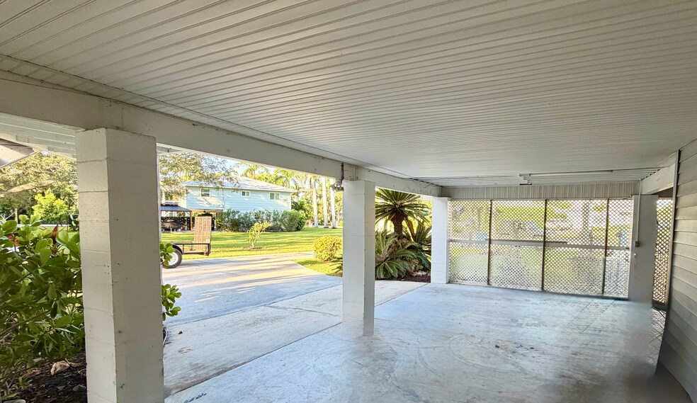 Under cover carport suited for two vehicles, kayaks, bikes and outside storage. - 5203 15th St W