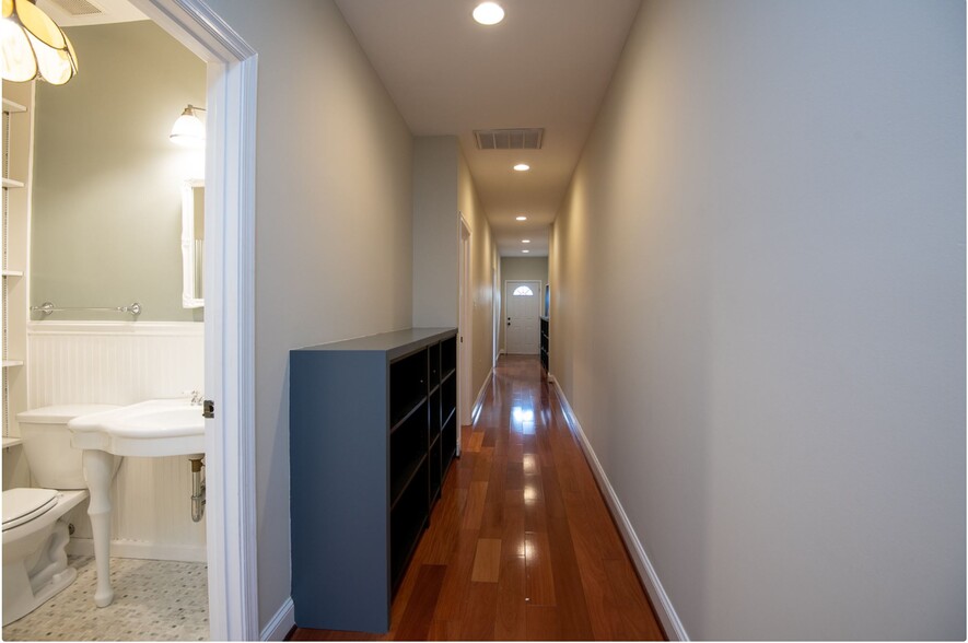 Hallway with bookshelves - 52 New York Ave NW
