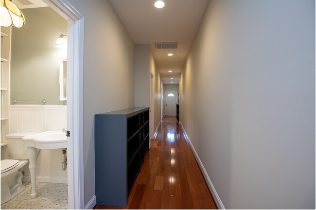 Hallway with bookshelves - 52 New York Ave NW