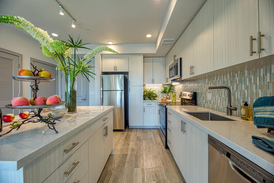 Light-filled kitchen with granite counters, energy-efficient appliances, and a clean, streamlined design. - Vespaio