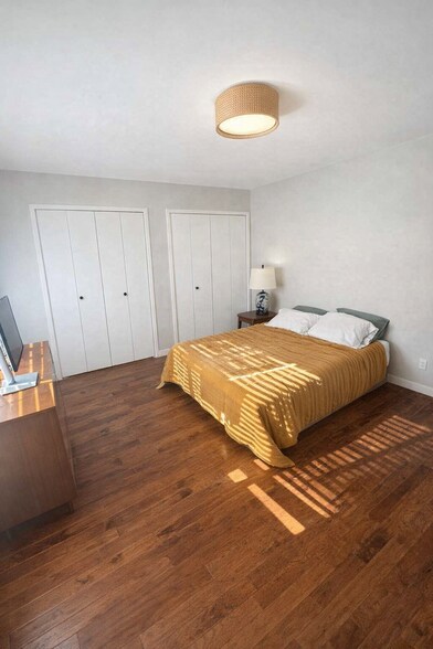 Spacious primary bedroom with generous closet space and room for a desk or seating area. - 524 Superior St