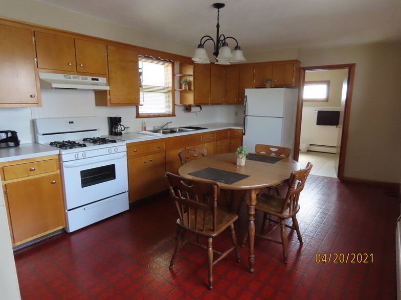 Fully stocked kitchen with pots, pans, dishes, and utensils. - 307 Center St