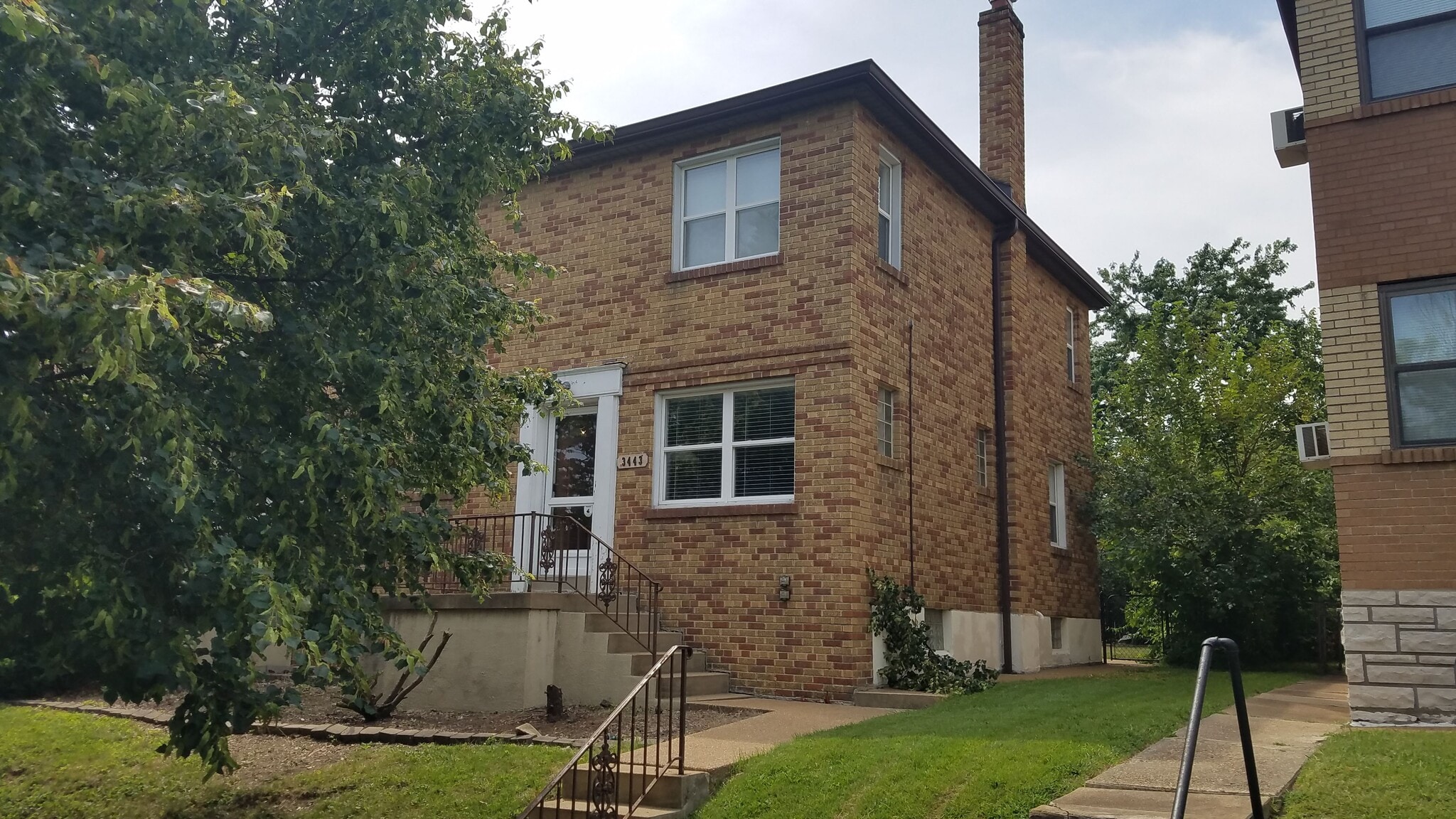 2 Story townhome. Features private entrance and private walk-out basement. Exterior railing has been painted and landscaping being updated. - 3443 Lawn Ave