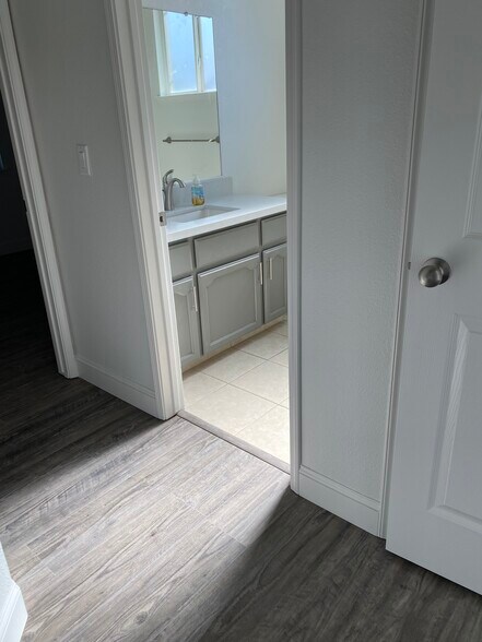 Hallway view; guest bathroom - 1134 Pine Ct