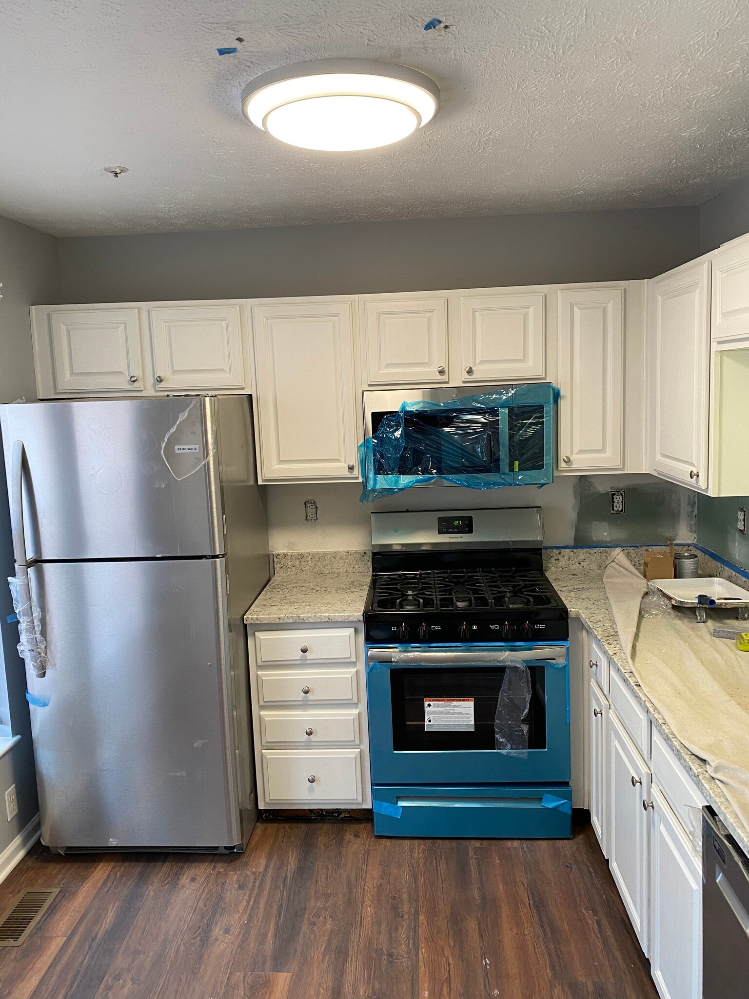 Fully renovated kitchen with granite countertops and brand new stainless steel appliances. - 7812 Foxfarm Ln