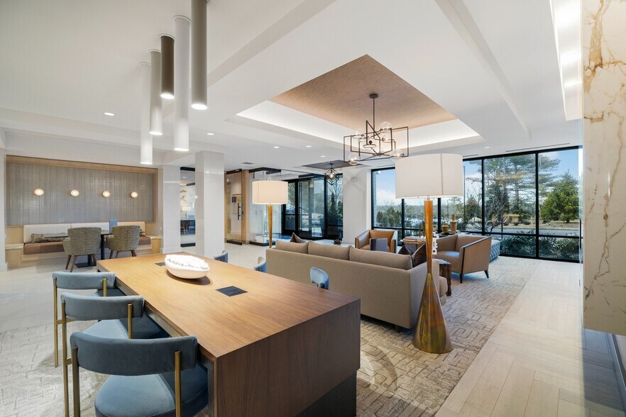 Ample coworking space with communal and booth seating - Berkshire at the Pinehills