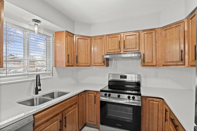 Experience culinary elegance in this beautifully designed kitchen, perfect for gourmet cooking. - 5580 West 4th Avenue Townhomes
