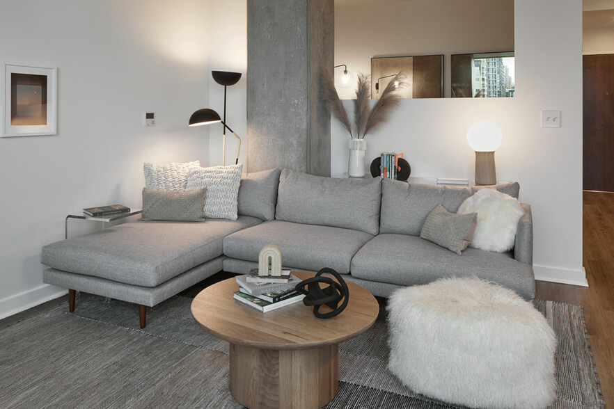 Apartment living room with wood-style flooring. - Griffis Seattle Waterfront