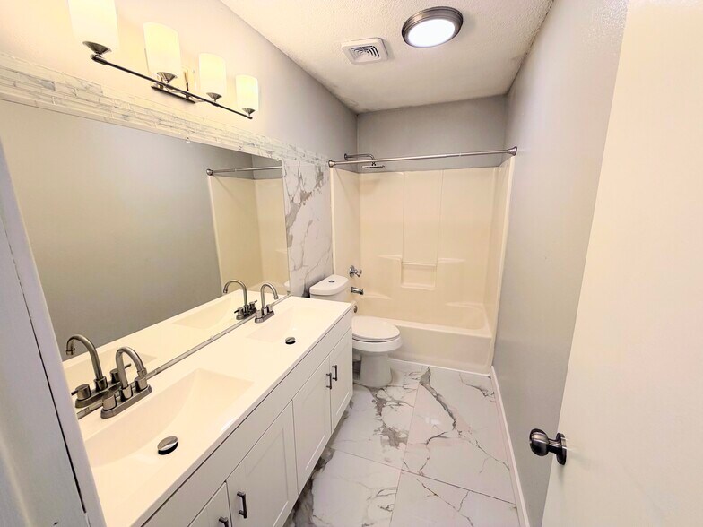 Marble bathroom with double vanity - 7501 April Ln